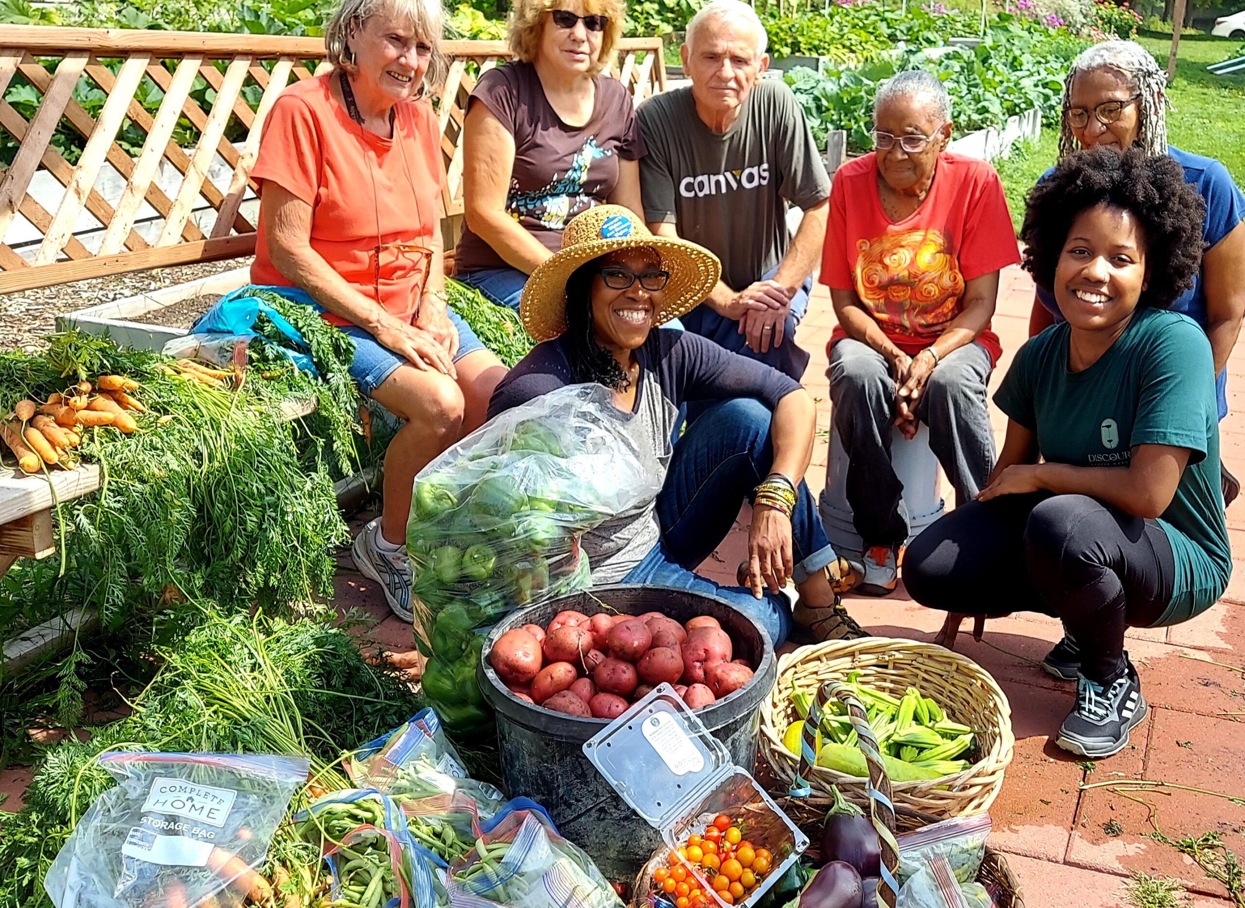 Volunteers tending a community garden with raised beds in Mequon, Wisconsin