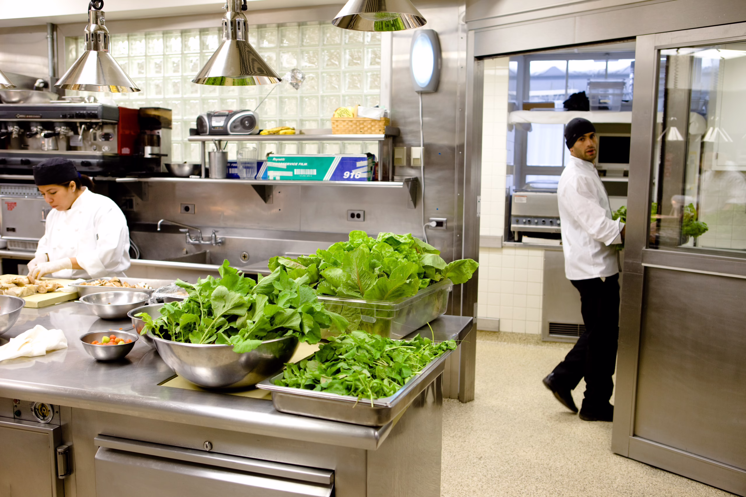 Radishes and lettuce from the newly planted White House kitchen garden being washed and prepared on a counter in the White House kitchen.